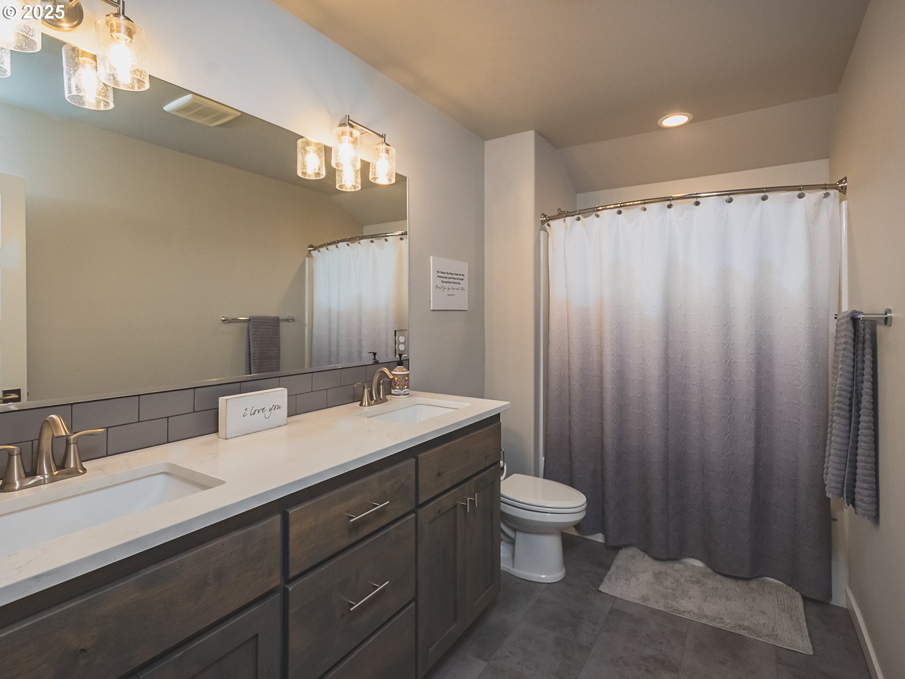 2116 North 3rd Way Ridgefield, WA 98642 - Photo 35 of 40 a bathroom with a double vanity sink toilet and a mirror