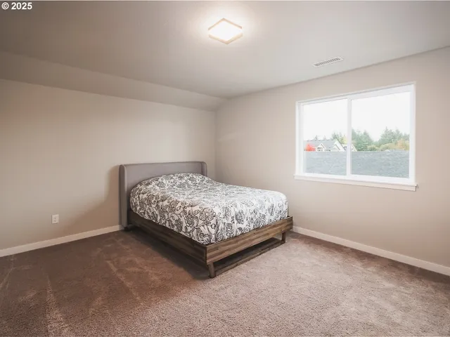 a bedroom with a bed and window