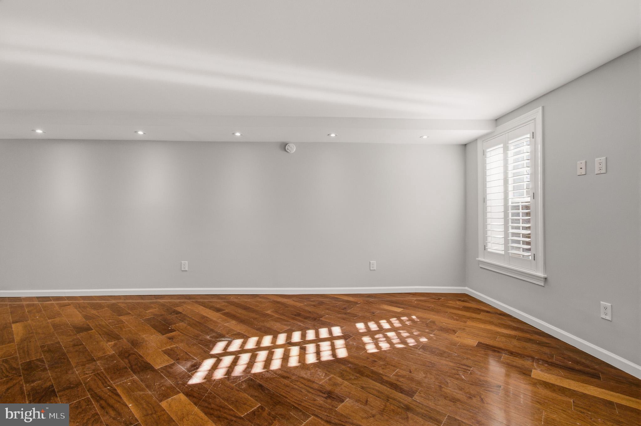 2117 S Street Northwest Washington, DC 20008 - Photo 21 of 63 wooden floor in an empty room with a window