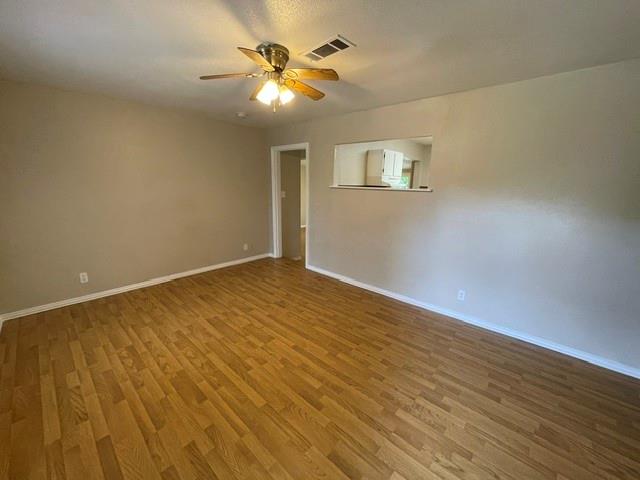 845 Rumfield Road White Settlement, TX 76108 - Photo 4 of 19 wooden floor in an empty room with a window