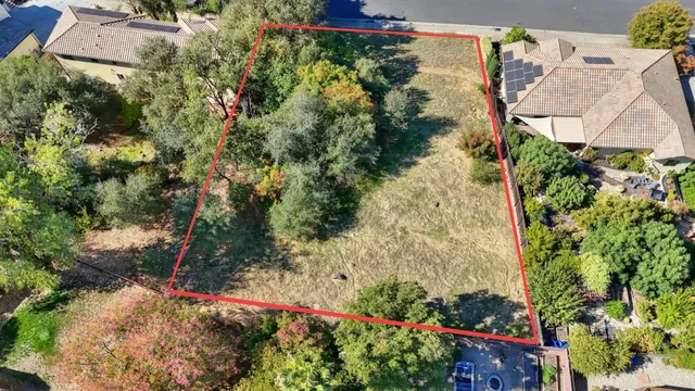 a big yard with lots of green space and mountain view in back