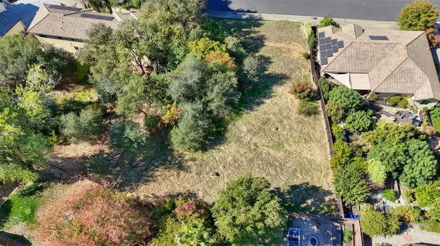 a view of a house with a yard and garden