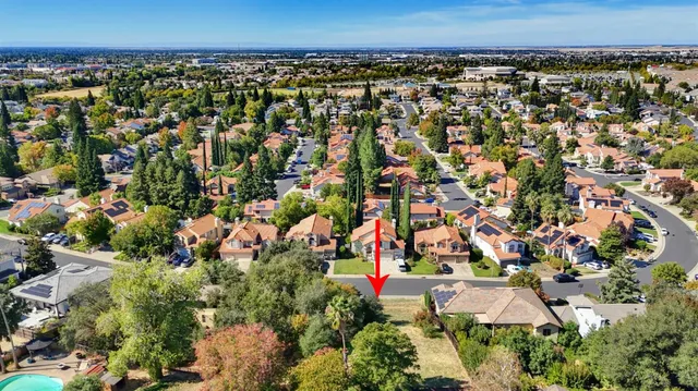an aerial view of residential houses with outdoor space