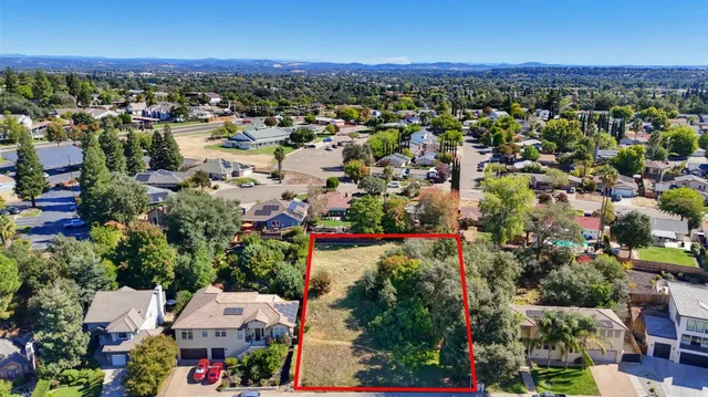 a view of a street with a houses in the background
