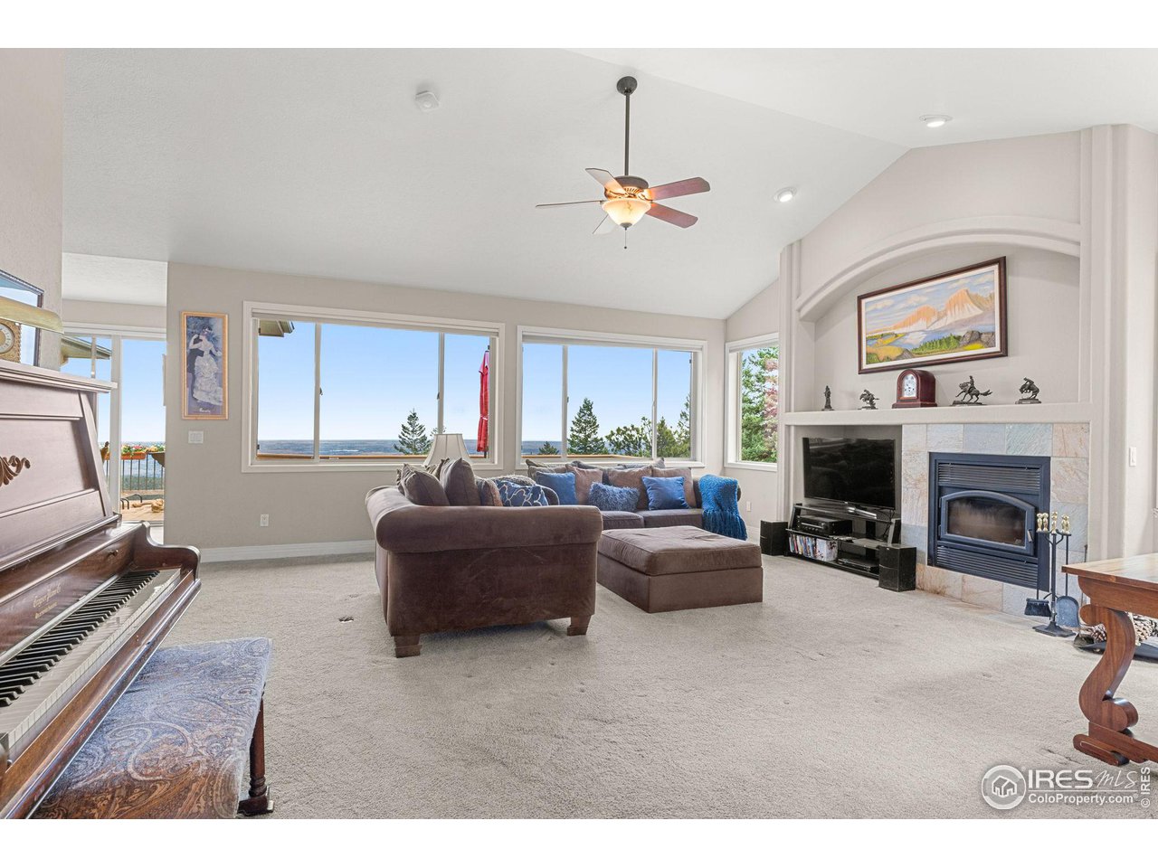 309 Sunrise Lane Boulder, CO 80302 - Photo 11 of 40 a living room with furniture a fireplace and a flat screen tv