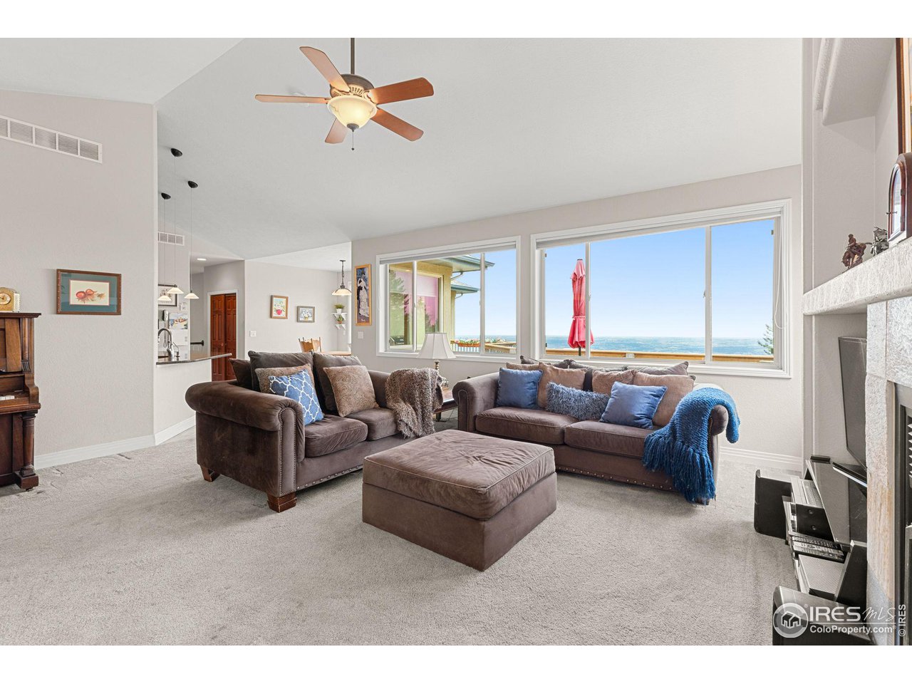 309 Sunrise Lane Boulder, CO 80302 - Photo 13 of 40 a living room with furniture a ceiling fan a fireplace and a window