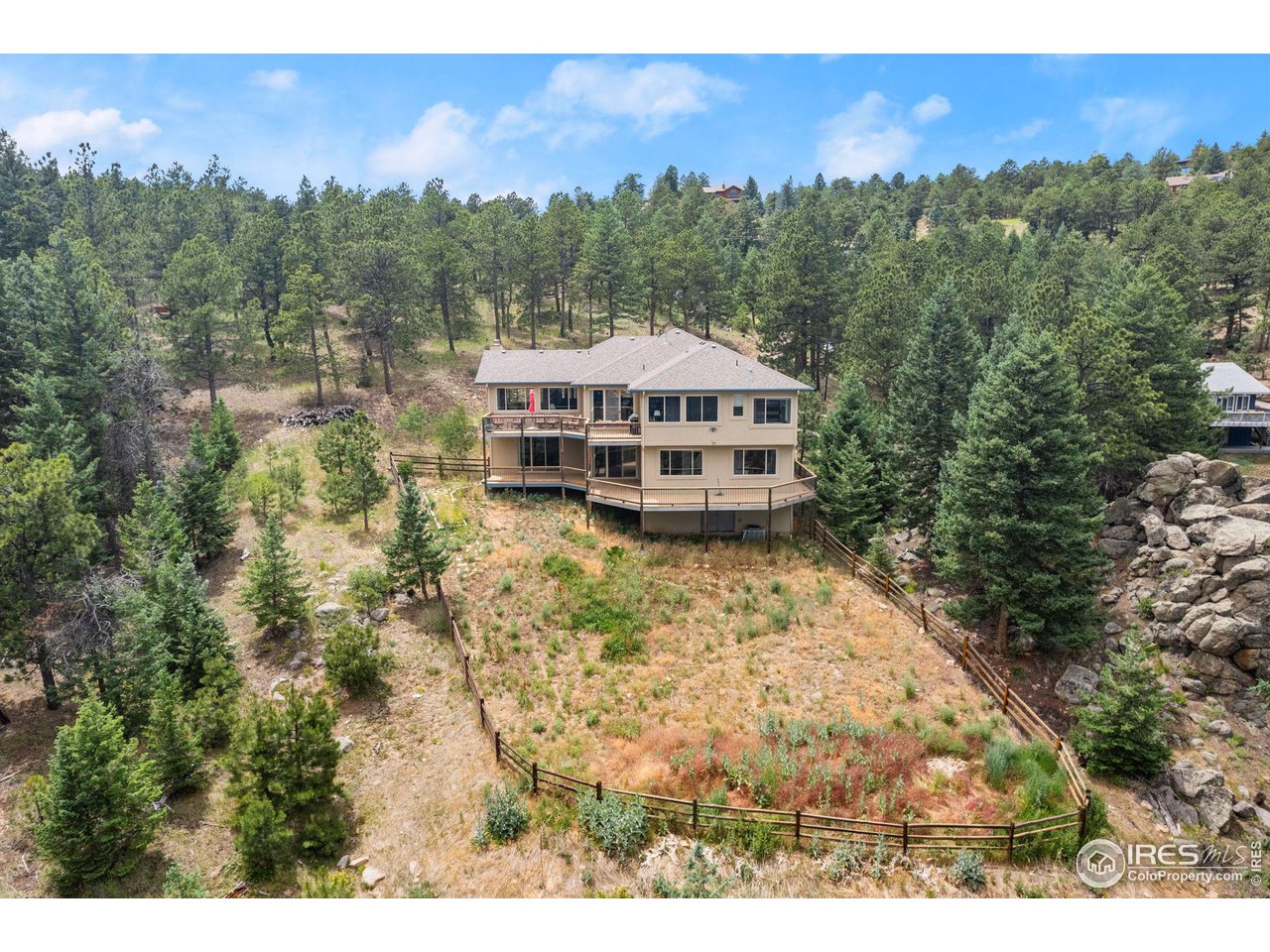 309 Sunrise Lane Boulder, CO 80302 - Photo 15 of 40 a view of a big house with a mountain in the background