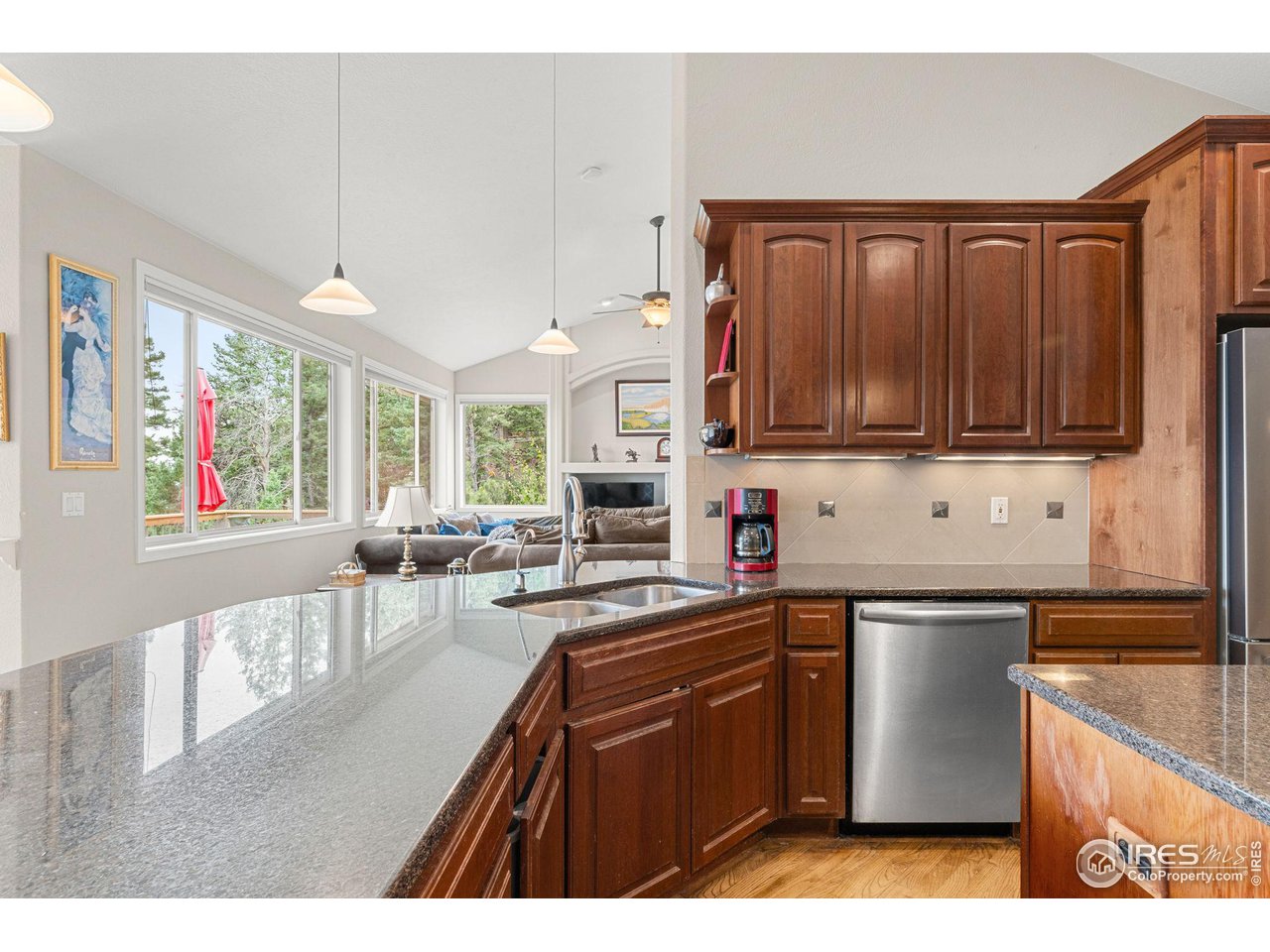 309 Sunrise Lane Boulder, CO 80302 - Photo 4 of 40 a kitchen with stainless steel appliances granite countertop a sink dishwasher stove and microwave with wooden cabinets