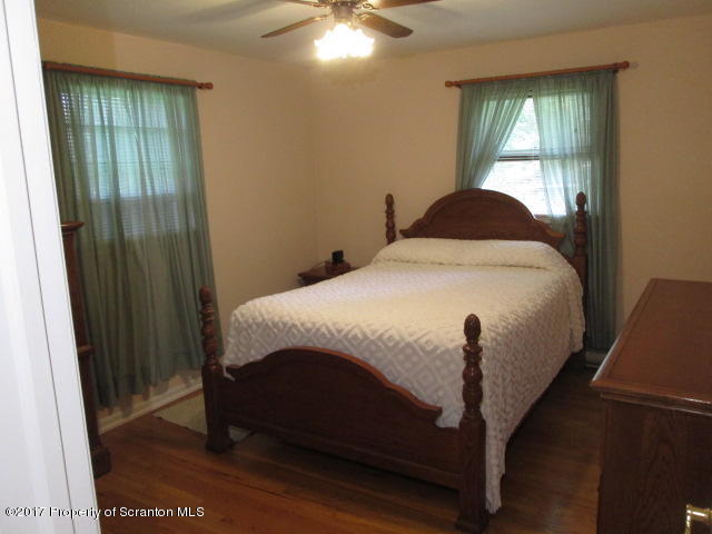 23 Swoyer Road Lake Ariel, PA 18436 - Photo 12 of 28 a bed sitting in a bedroom next to a window