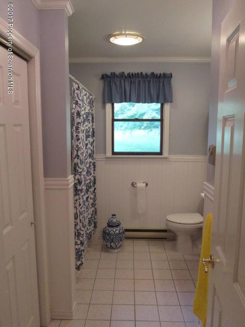 23 Swoyer Road Lake Ariel, PA 18436 - Photo 17 of 28 a bathroom with a toilet and a shower curtain