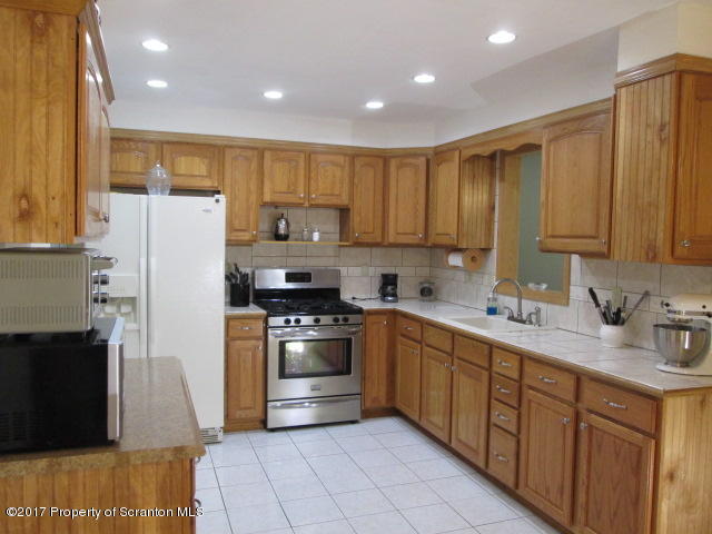 23 Swoyer Road Lake Ariel, PA 18436 - Photo 2 of 28 a kitchen with a sink a refrigerator and cabinets
