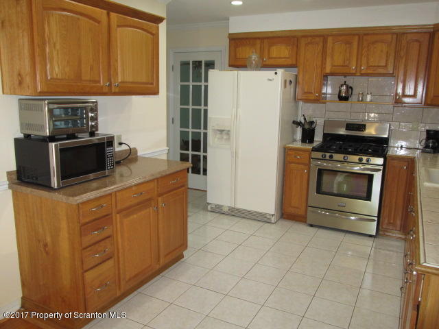 23 Swoyer Road Lake Ariel, PA 18436 - Photo 3 of 28 a kitchen with stainless steel appliances granite countertop a refrigerator oven a stove with white cabinets