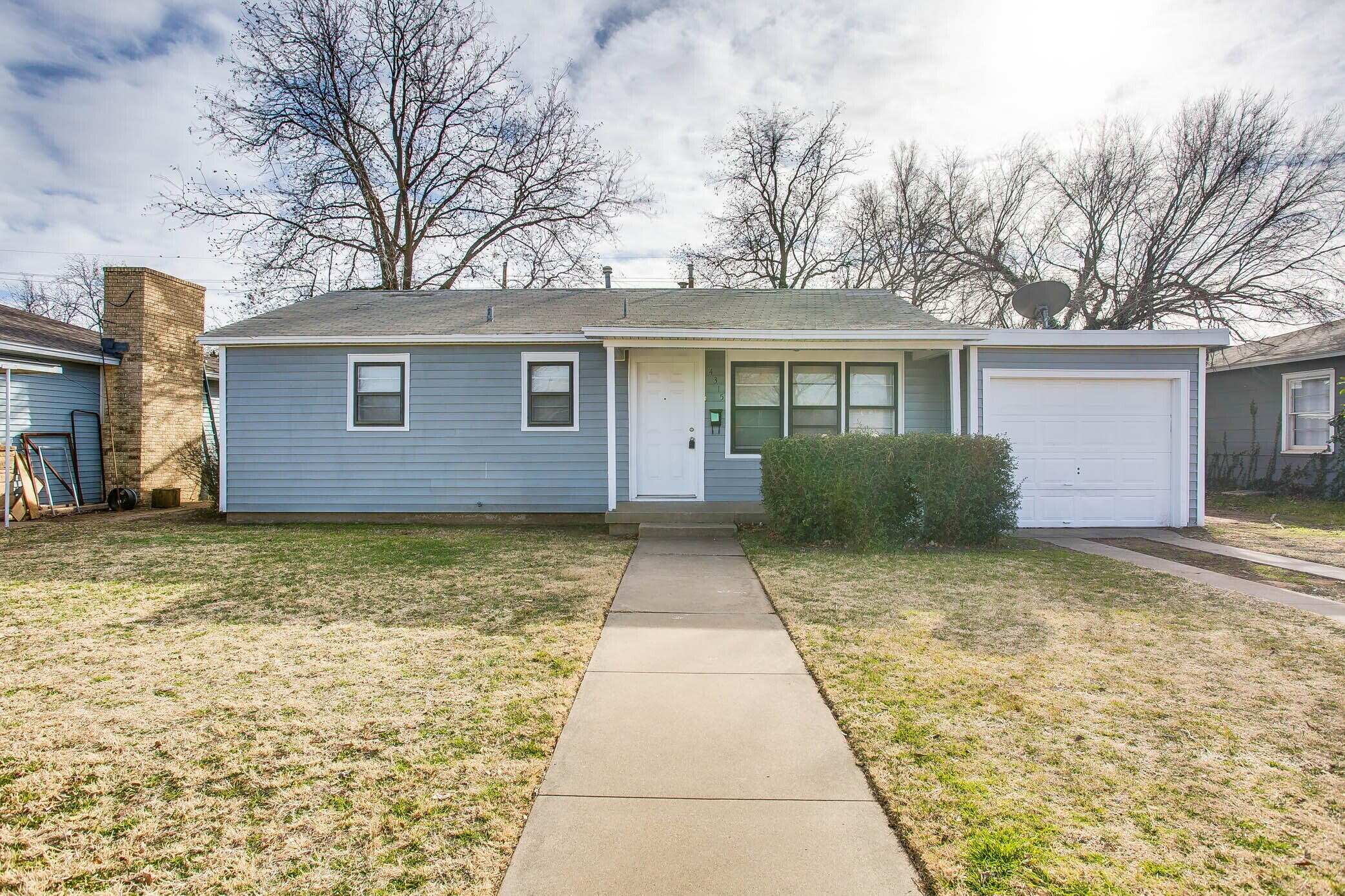 4315 32nd Street Lubbock, TX 79410 - Photo 1 of 15 front view of house with a yard