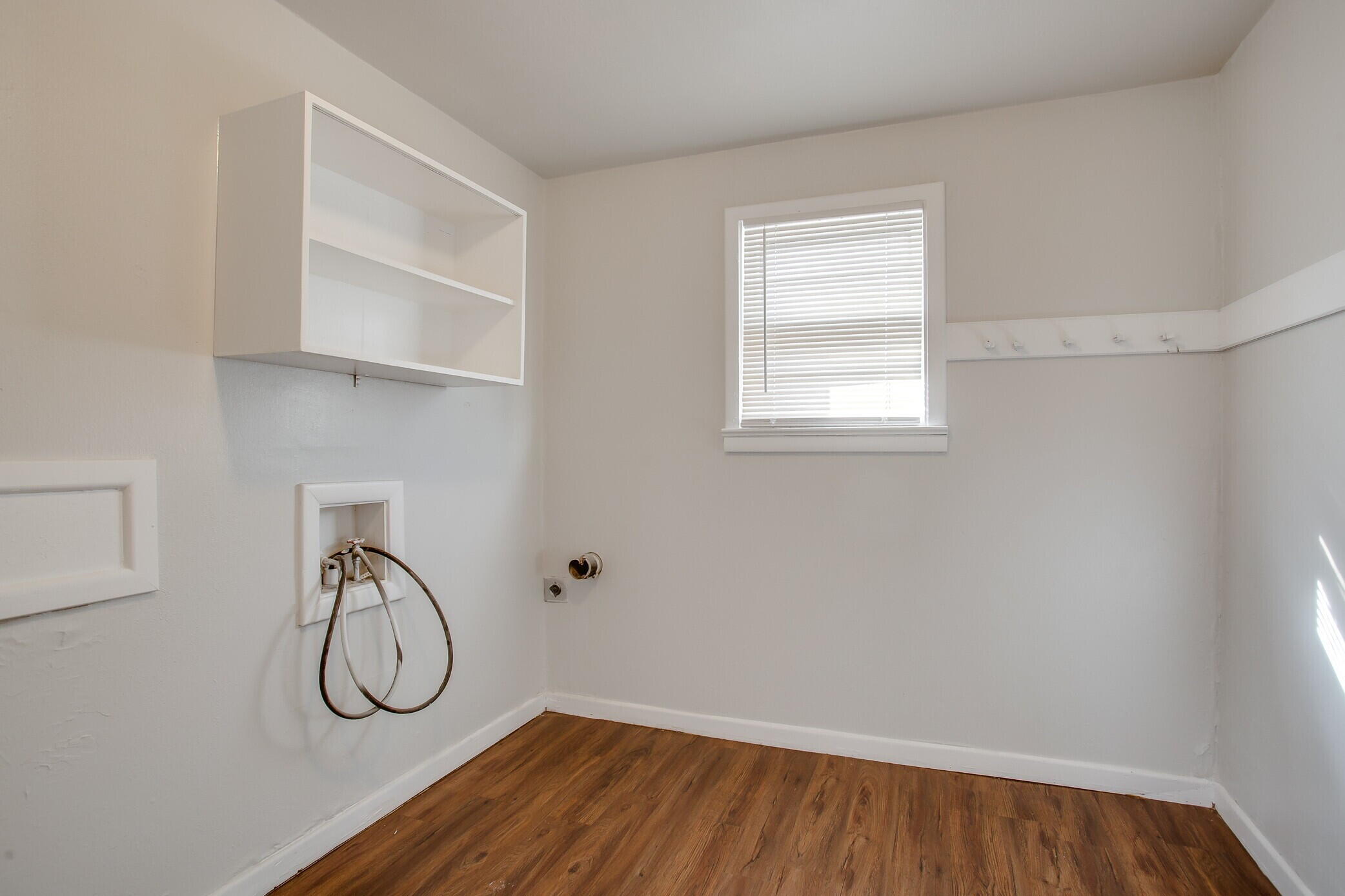4315 32nd Street Lubbock, TX 79410 - Photo 14 of 15 a view of a room with wooden floor and windows
