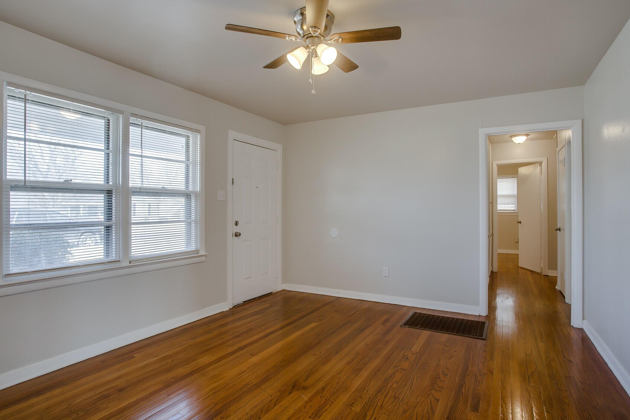 4315 32nd Street Lubbock, TX 79410 - Photo 2 of 15 a view of empty room with wooden floor and fan