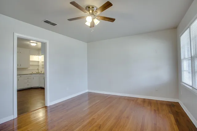 wooden floor in an empty room with a window