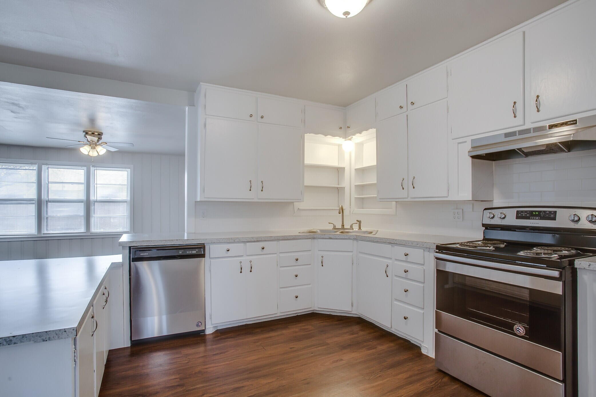 4315 32nd Street Lubbock, TX 79410 - Photo 4 of 15 a kitchen with granite countertop a sink a stove and cabinets
