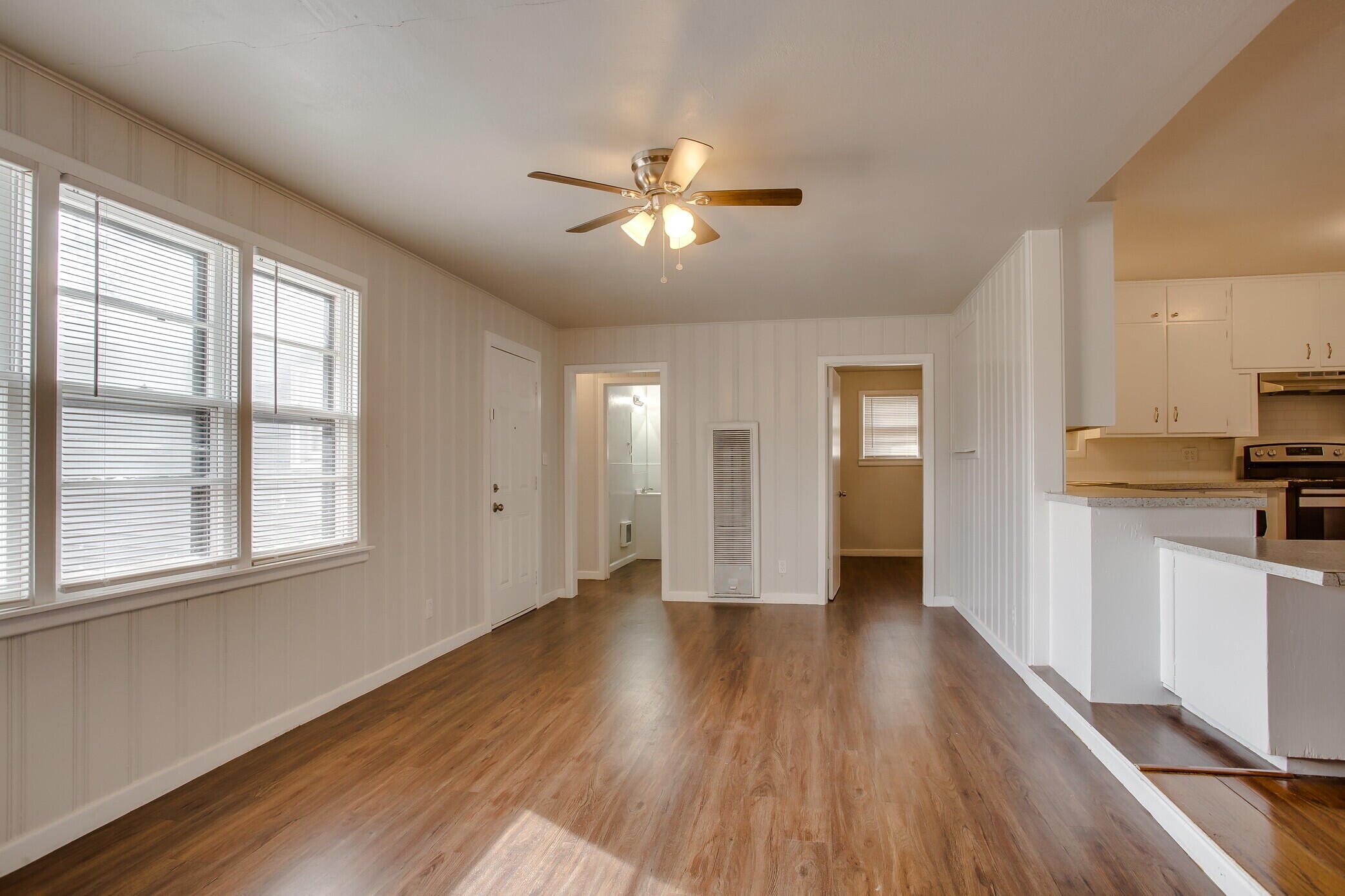 4315 32nd Street Lubbock, TX 79410 - Photo 7 of 15 a view of an empty room with window and wooden floor