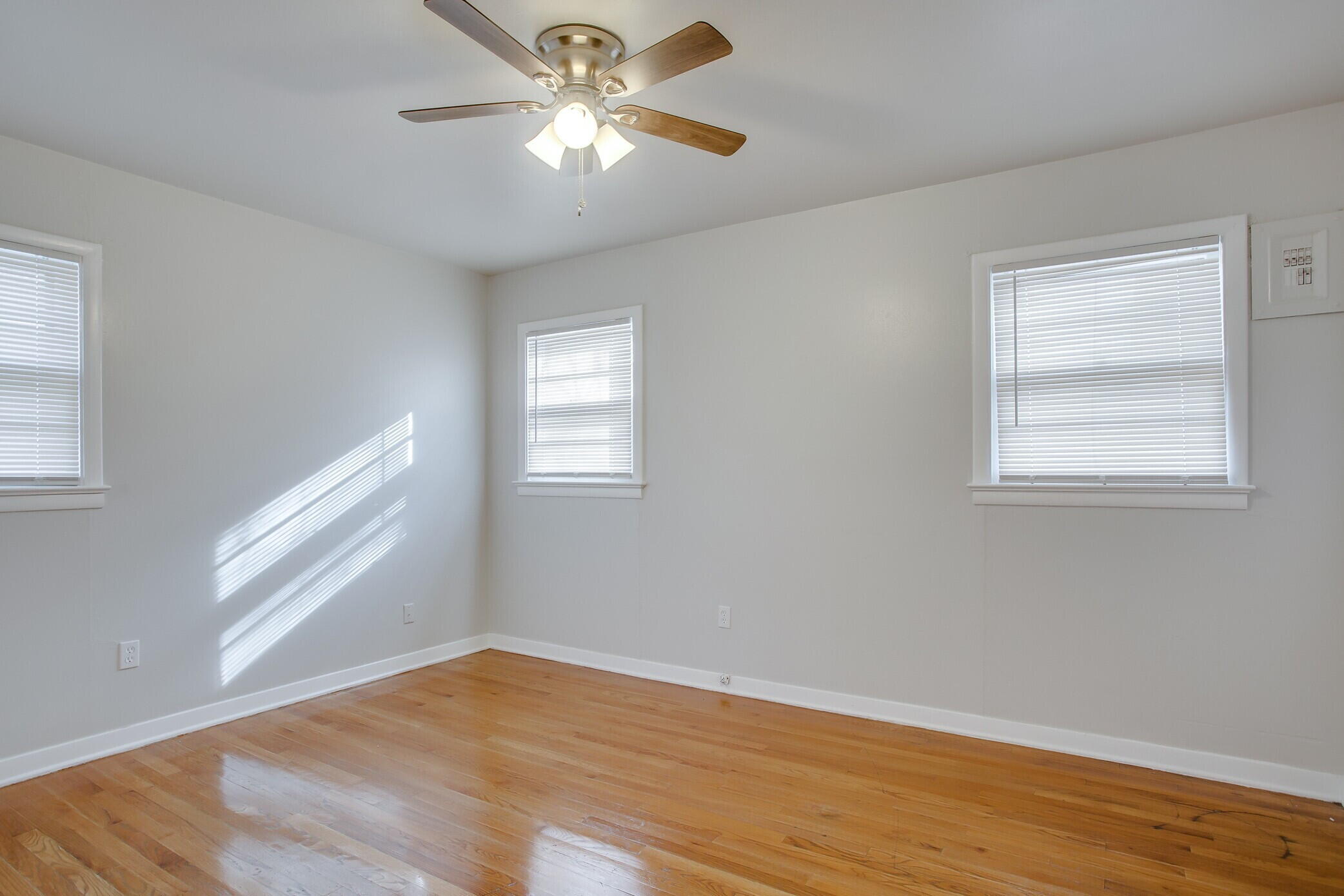 4315 32nd Street Lubbock, TX 79410 - Photo 9 of 15 a view of empty room with wooden floor and fan