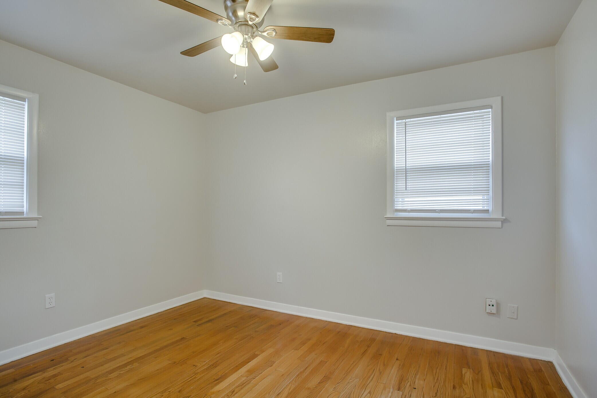 4315 32nd Street Lubbock, TX 79410 - Photo 10 of 15 a view of an empty room with wooden floor and a window