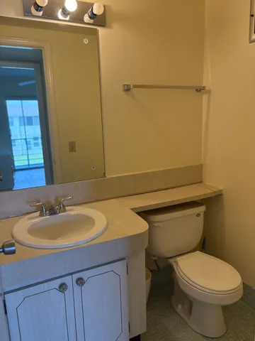 an empty room with wooden floor and cabinet