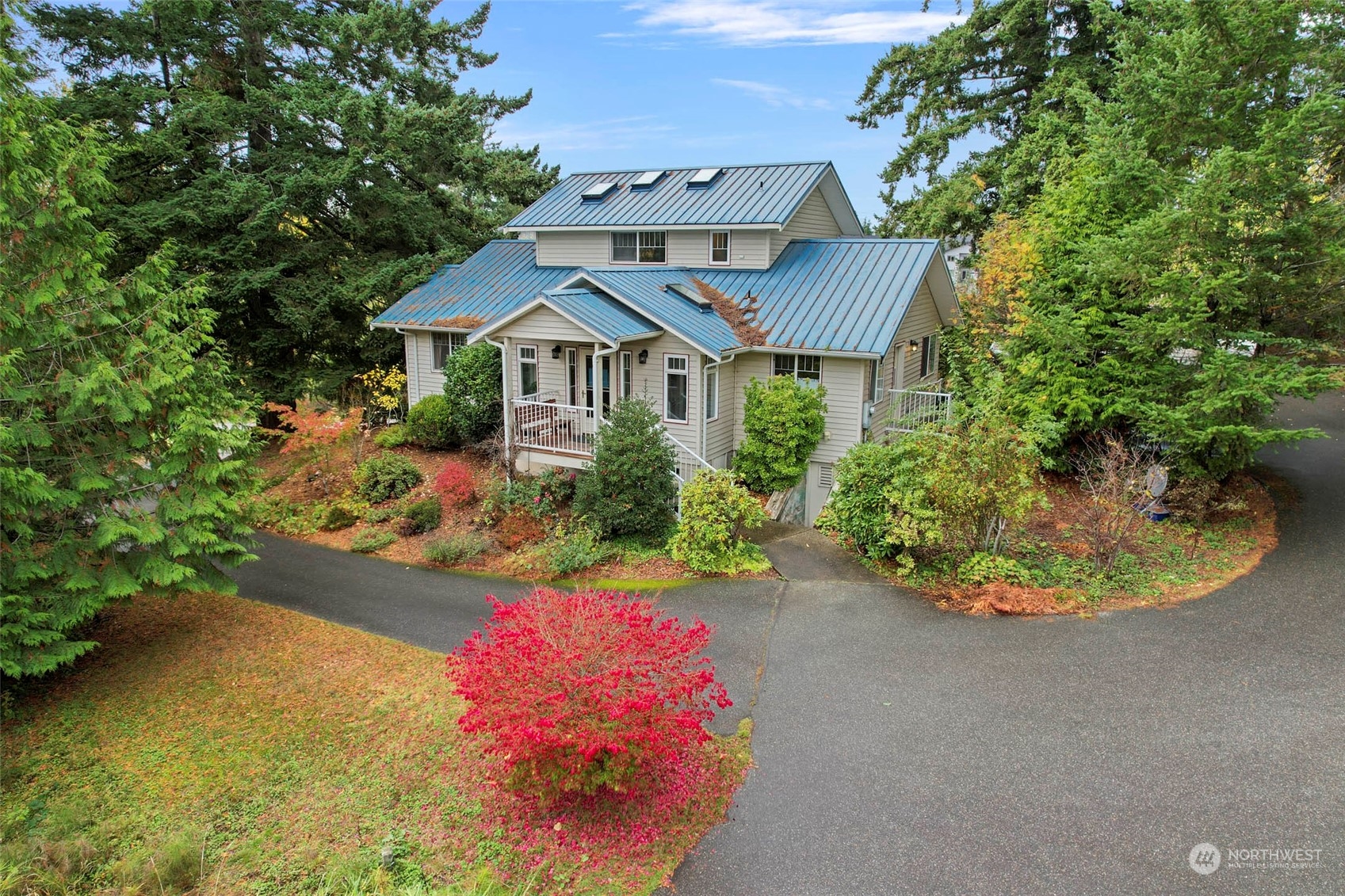 a view of a house with a yard and potted plants
