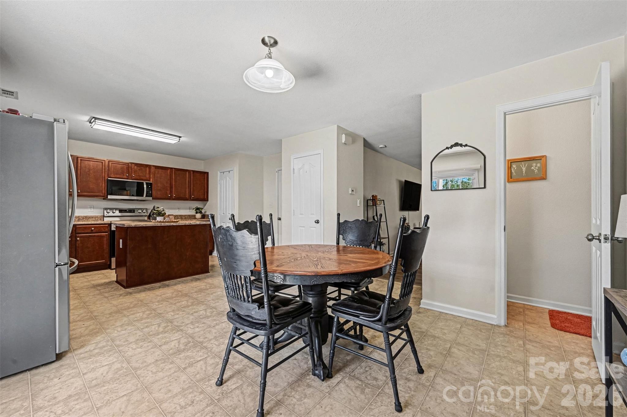 4804 Manchineel Lane Monroe, NC 28110 - Photo 11 of 28 a view of a dining room with furniture and a kitchen view