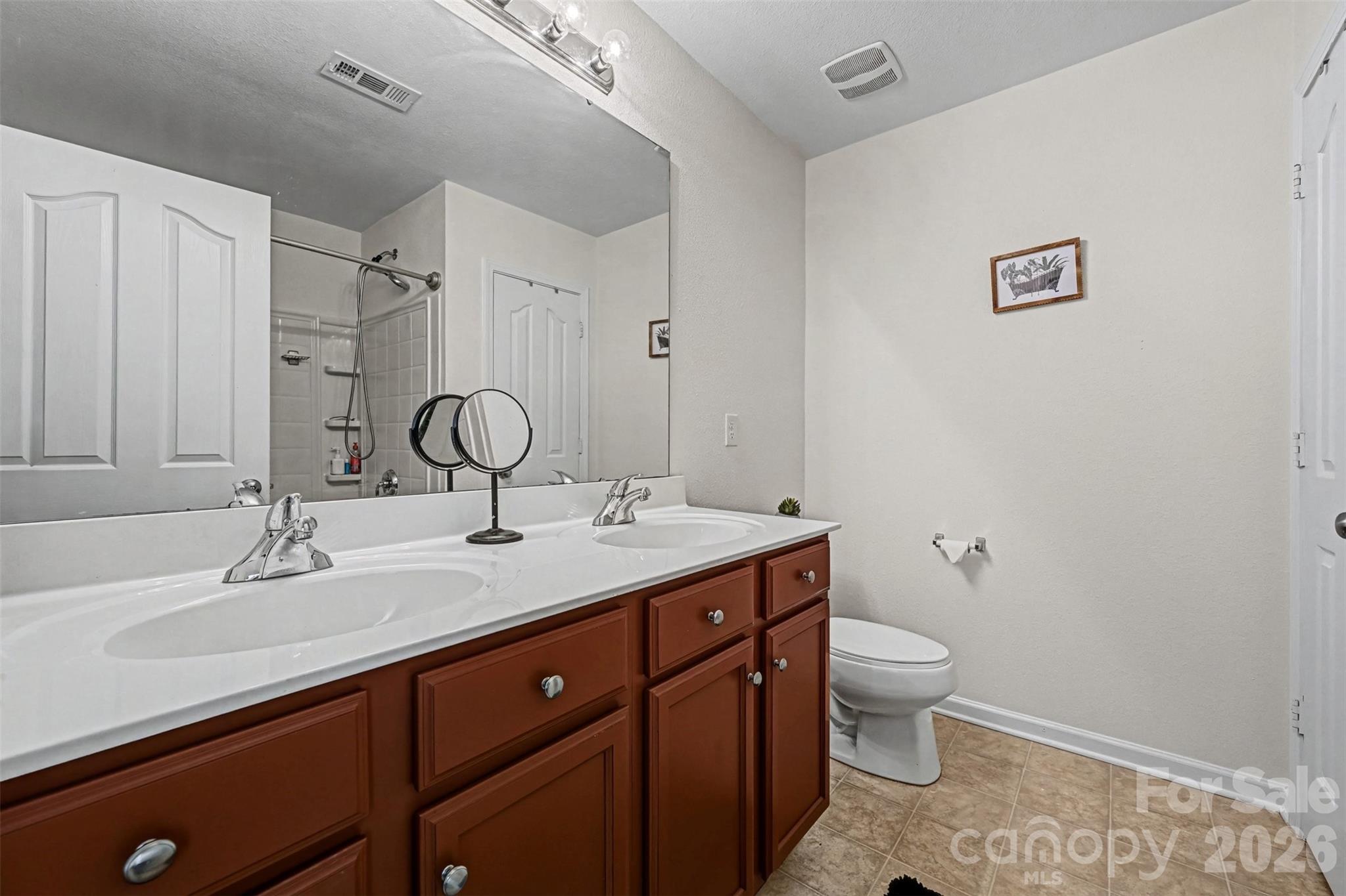 4804 Manchineel Lane Monroe, NC 28110 - Photo 17 of 28 a bathroom with a granite countertop sink a toilet and a mirror