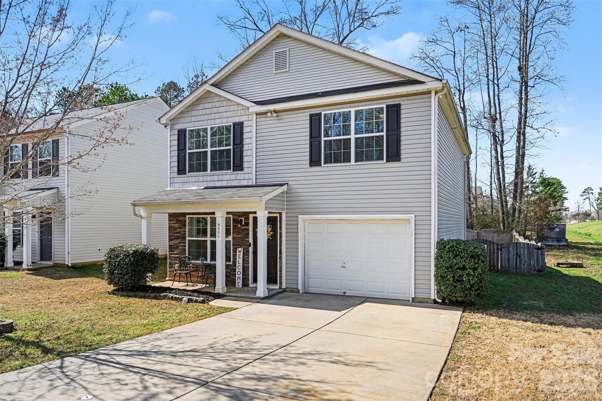 4804 Manchineel Lane Monroe, NC 28110 - Photo 28 of 28 a view of a white house with a yard and large windows