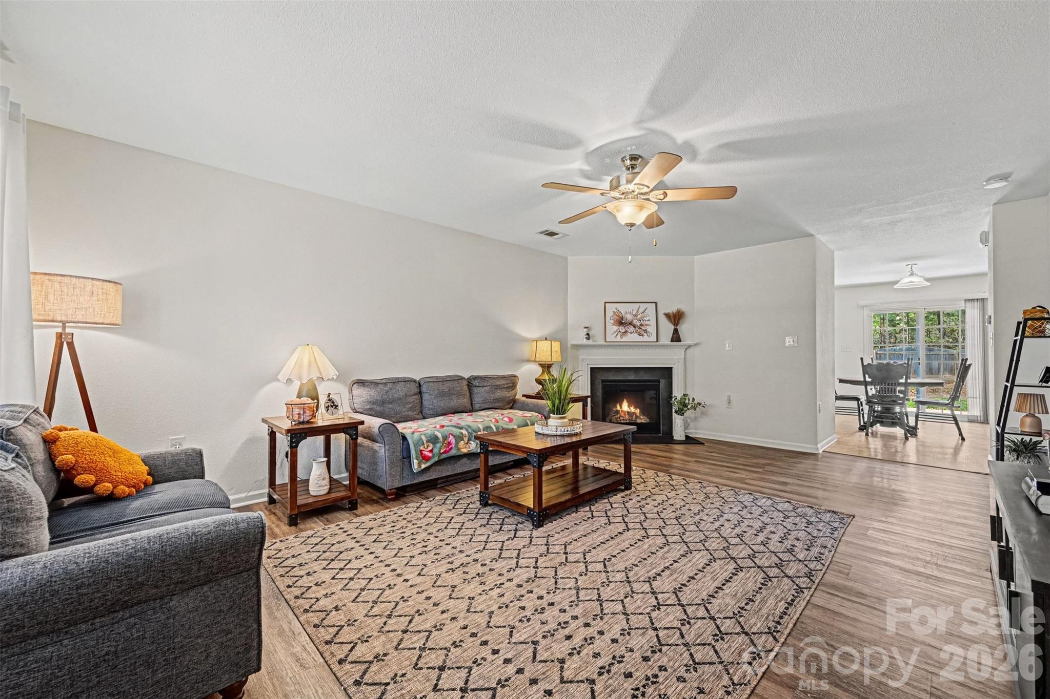 4804 Manchineel Lane Monroe, NC 28110 - Photo 5 of 28 a living room with furniture a fireplace and a chandelier