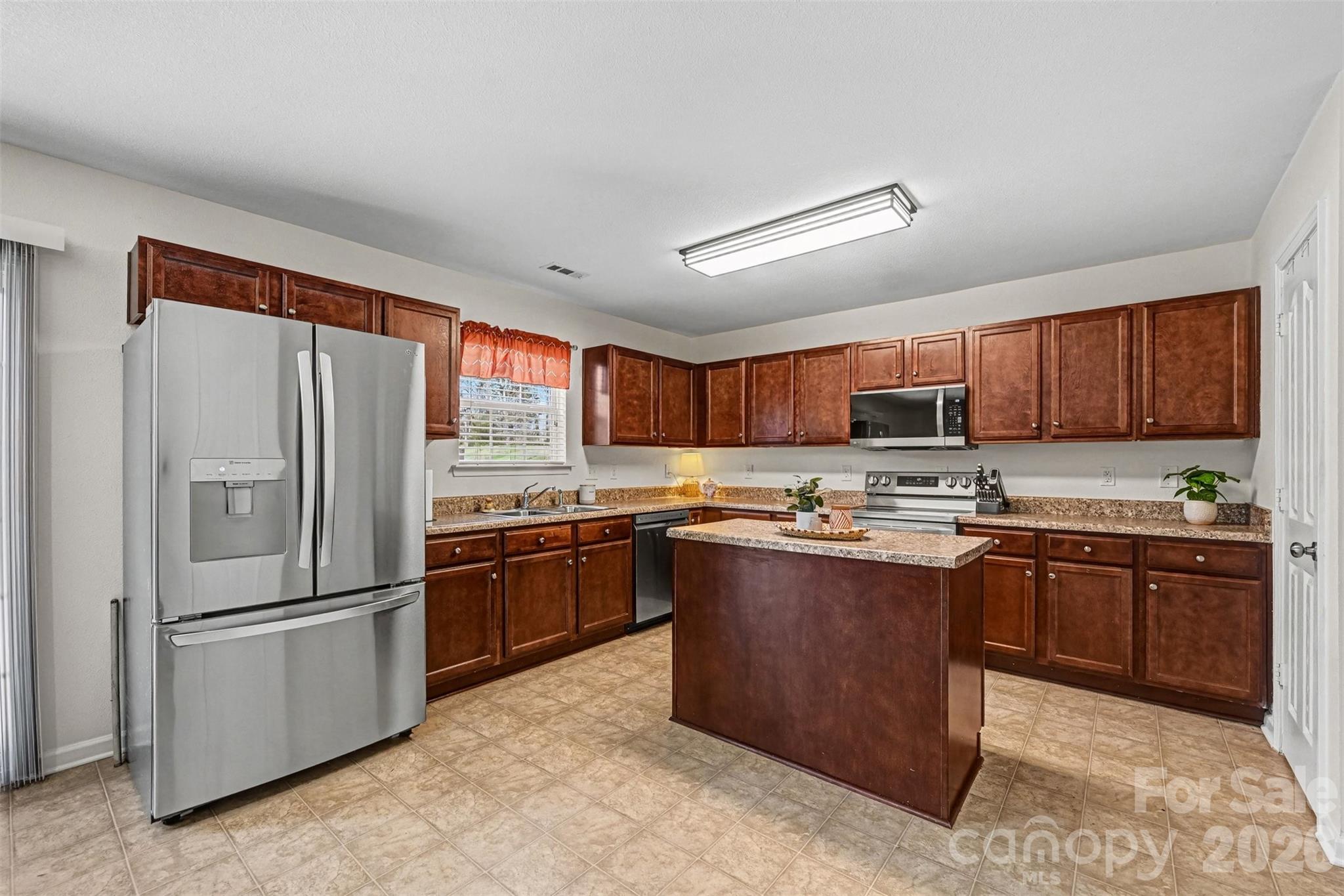 4804 Manchineel Lane Monroe, NC 28110 - Photo 7 of 28 a kitchen with stainless steel appliances granite countertop a refrigerator a sink dishwasher a stove top oven a refrigerator and cabinets