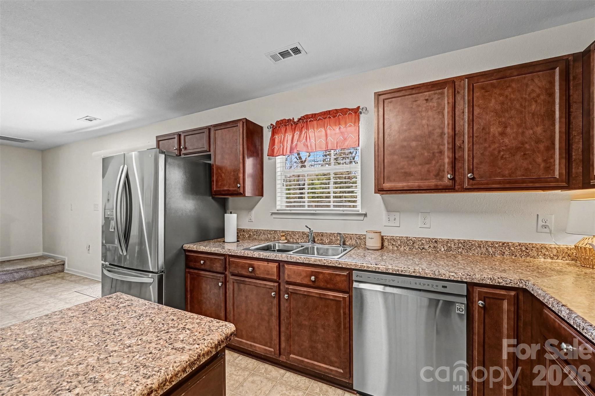4804 Manchineel Lane Monroe, NC 28110 - Photo 8 of 28 a kitchen with stainless steel appliances granite countertop a sink stove and refrigerator