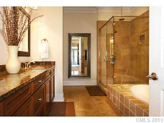 626 Queens Road, Unit 103 Charlotte, NC 28207 - Photo 14 of 16 a bathroom with a granite countertop sink mirror and shower