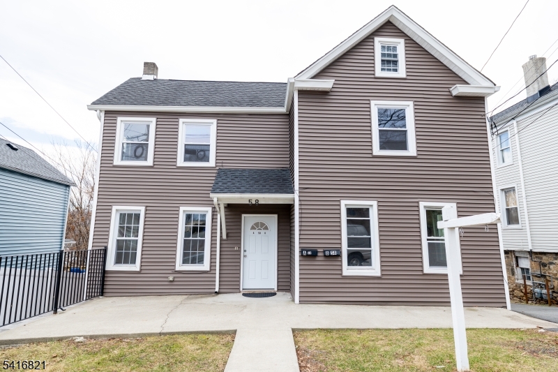 58 Prospect Street, Unit A Dover, NJ 07801 - Photo 1 of 10 a front view of a house with a yard