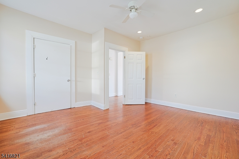 58 Prospect Street, Unit A Dover, NJ 07801 - Photo 3 of 10 a view of an empty room with wooden floor