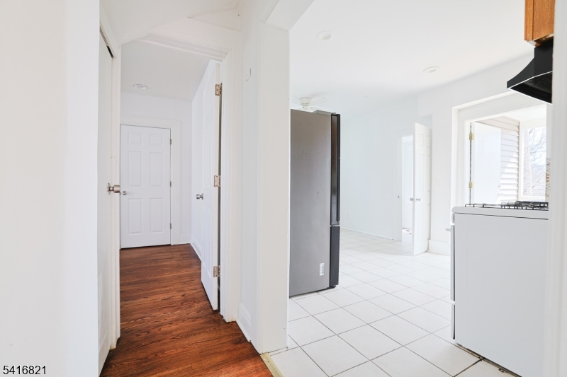 58 Prospect Street, Unit A Dover, NJ 07801 - Photo 7 of 10 a view of a hallway with wooden floor and staircase