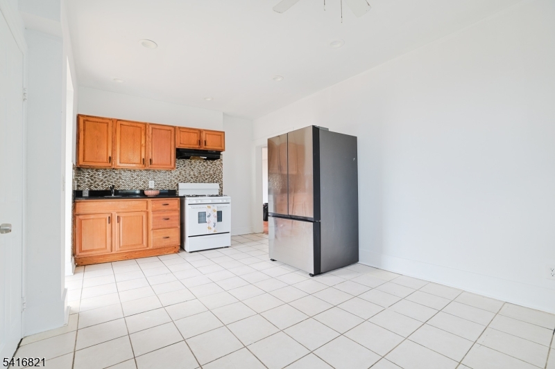 58 Prospect Street, Unit A Dover, NJ 07801 - Photo 8 of 10 a kitchen with stainless steel appliances a refrigerator sink and cabinets