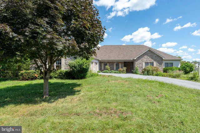 a front view of house with yard and green space