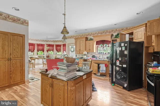 a open kitchen with stainless steel appliances granite countertop a stove and refrigerator