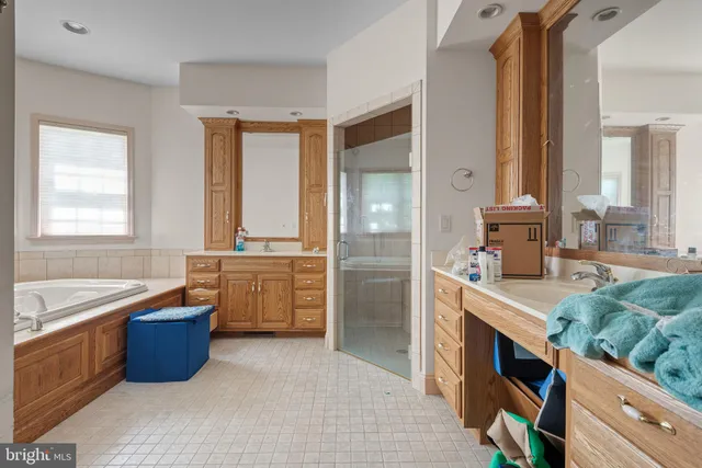 a room with kitchen island granite countertop a stove and a sink