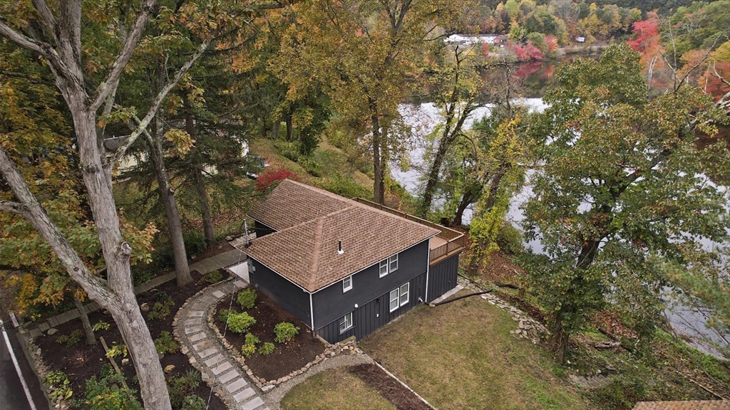 a roof deck with table and chairs under an umbrella