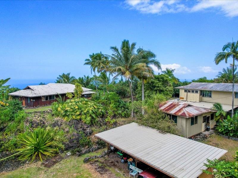 84-5193 Hawaiʻi Belt Road Captain Cook, HI 96704 - Photo 14 of 30 an outdoor space with furniture and umbrella