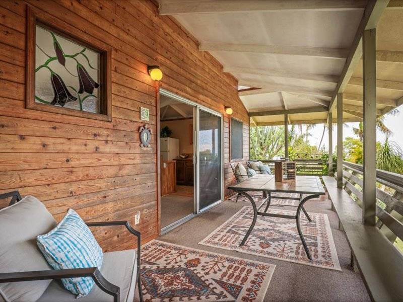 84-5193 Hawaiʻi Belt Road Captain Cook, HI 96704 - Photo 23 of 30 a living room with furniture wooden floor and a table