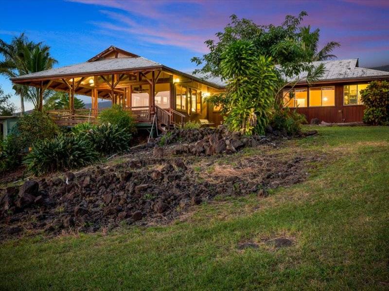 84-5193 Hawaiʻi Belt Road Captain Cook, HI 96704 - Photo 3 of 30 a front view of house with yard and outdoor seating