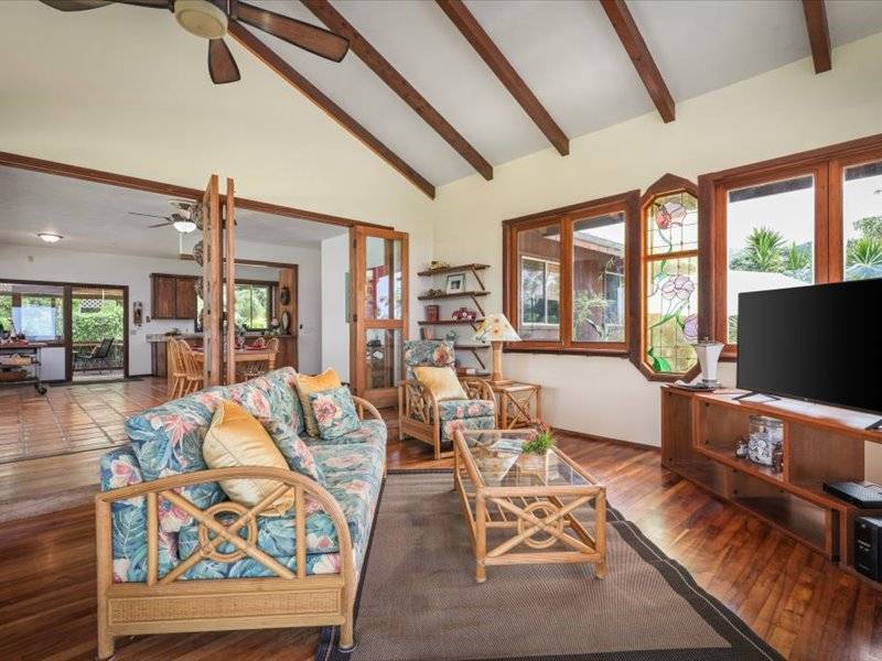84-5193 Hawaiʻi Belt Road Captain Cook, HI 96704 - Photo 7 of 30 a living room with furniture a rug and a flat screen tv