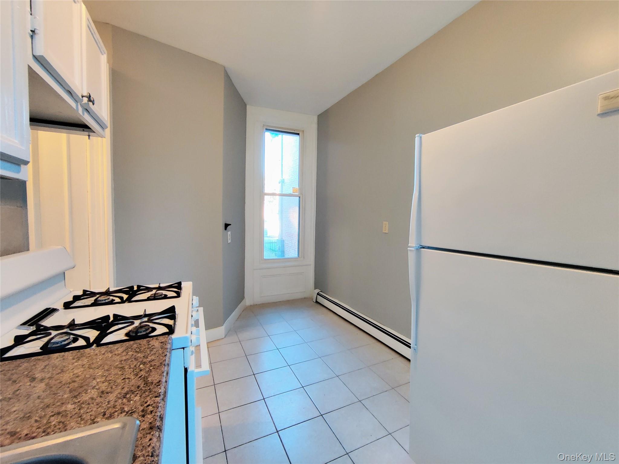20 Noxon Street, Unit 1 Poughkeepsie, NY 12601 - Photo 12 of 15 a kitchen with a refrigerator and a stove