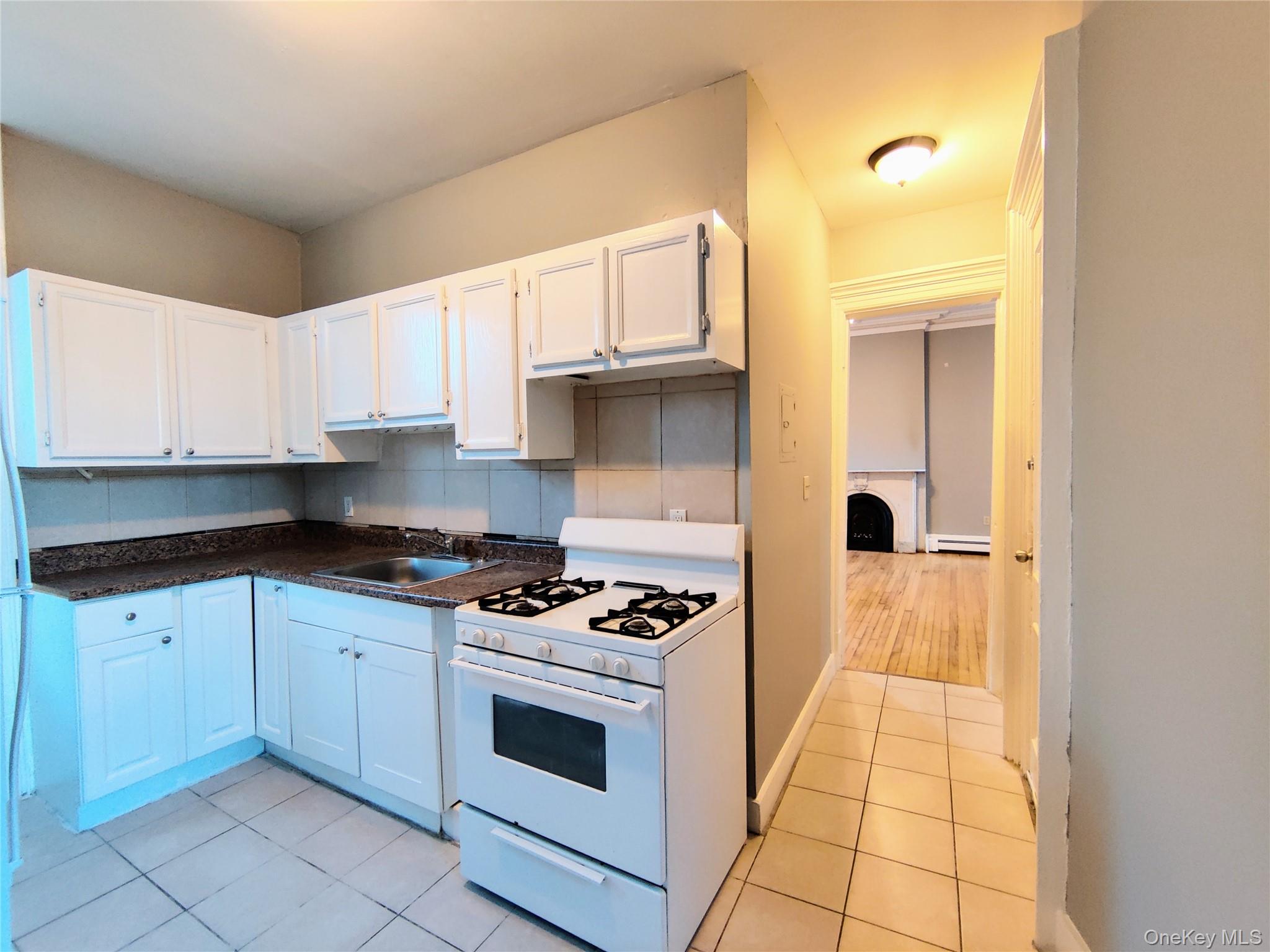 20 Noxon Street, Unit 1 Poughkeepsie, NY 12601 - Photo 15 of 15 a kitchen with granite countertop a stove a sink and a microwave