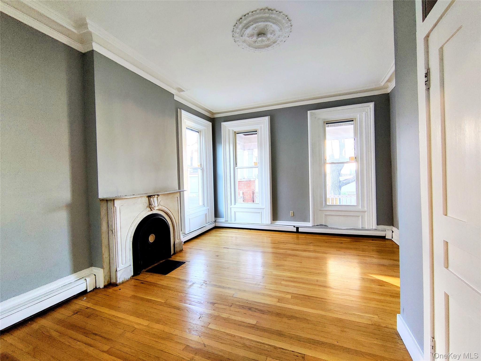 20 Noxon Street, Unit 1 Poughkeepsie, NY 12601 - Photo 6 of 15 a view of empty room with fireplace and wooden floor