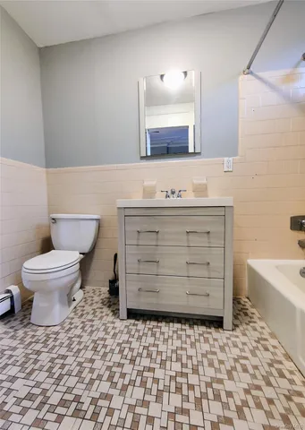 a bathroom with a sink a toilet and bathtub