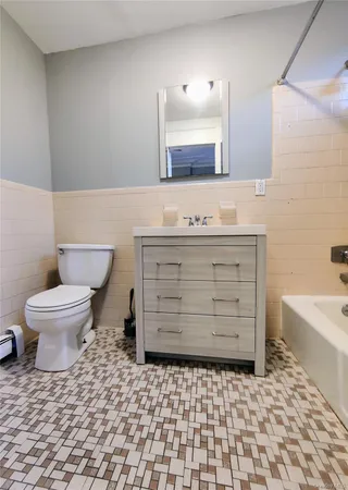 a bathroom with a sink a toilet and bathtub